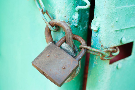 Metal door with Two old rusty padlock. Copy space. Security and 