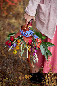 Girl walking in the autumn forest. A large beautiful bouquet of 