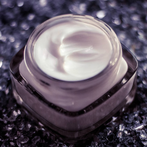 Luxury face cream for healthy skin on shiny glitter background, 