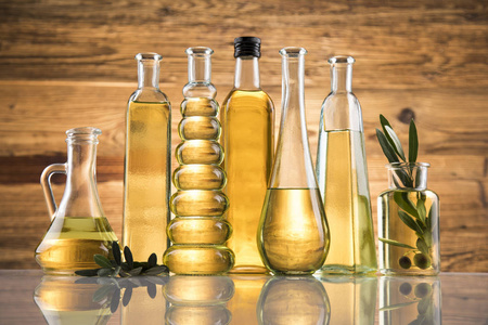 Olive oil bottles, olive branch and Cooking oils 