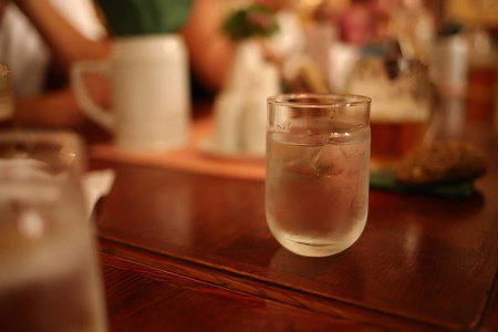 在一家餐馆里，一杯水放在一张木桌上