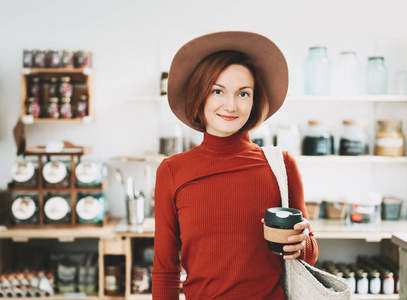 Young woman in zero waste shop. 