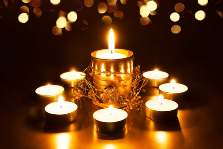 Christmas decoration with burning candles on a dark background. 