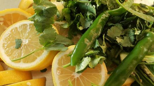 Top view of fresh lemon slices with green pepper cut into pieces