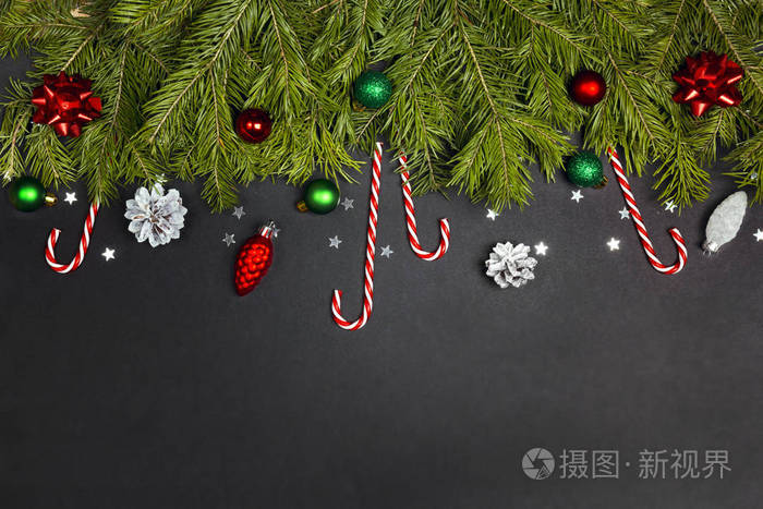 Christmas border from fir branches, decorations and candy canes 