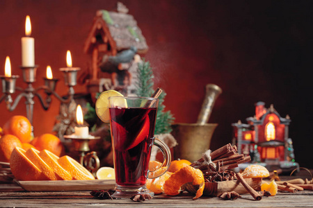 Mulled wine and Christmas decorations with candlesticks. 