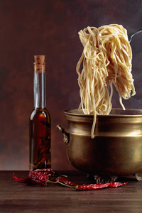 Homemade  egg noodles and old brass pan with hot water. 