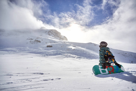  Snowboarder enjoying winter vacations in mountains.