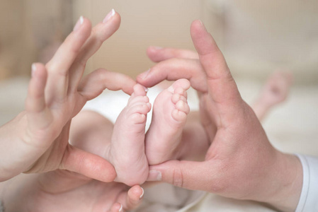 家庭幸福时刻。新出生的脚印照片。有婴儿标志的父母。