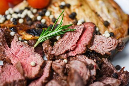 Roasted beef steak fillet with herb and spices served on wooden 