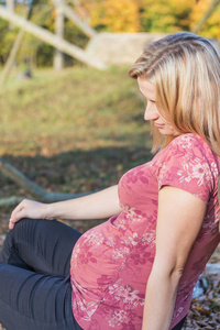 Side view of relaxing young pregnant woman 