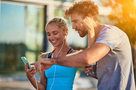 Modern woman and man jogging  exercising in urban surroundings 