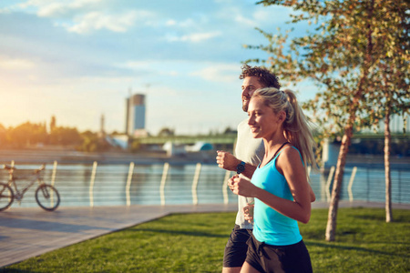 Modern woman and man jogging  exercising in urban surroundings 