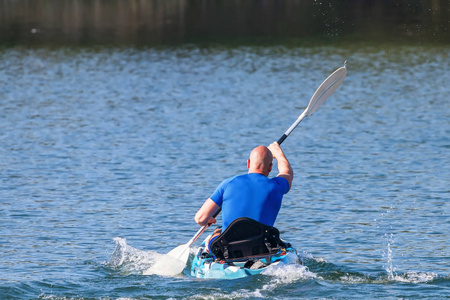 Young Man Kayaking on Lake. Lake Kayaking. 