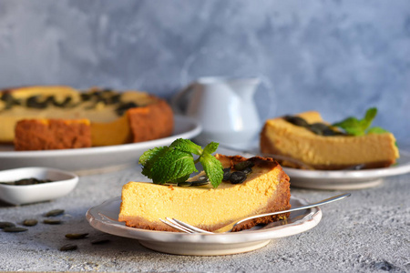 Slice of pumpkin cheesecake with seeds 