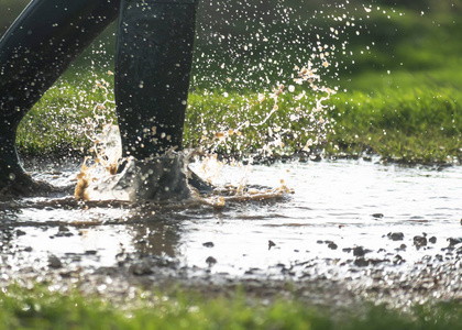 person walking in puddles early in the morning 