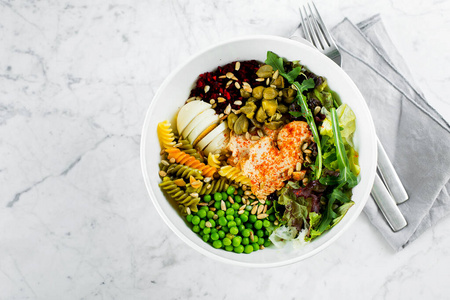 Healthy lunch bowl. Chicken, pasta fusilli, capers, mix greens, 