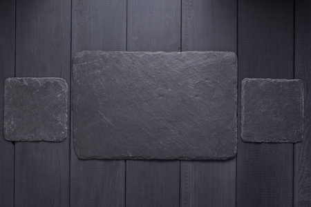 slate stone nameplate or wall sign at wooden background 