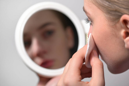 Girl Wipes Her Face With A Cotton Pad 