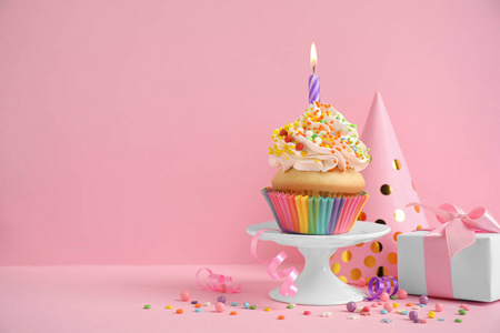 Composition with birthday cupcake on pink background. Space for 