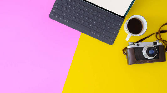 Top view of modern workspace with digital tablet and camera on y