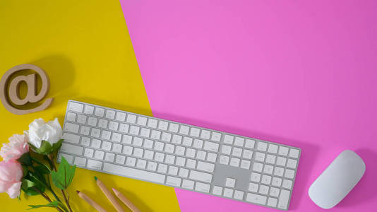 Top view of colourful workspace with keyboard and  supplie