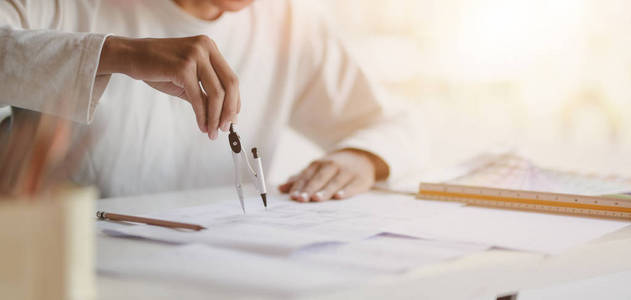 Closeup view of young professional architect working on working