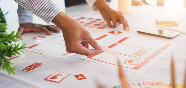 Cropped shot of professional UI web developer team working on 