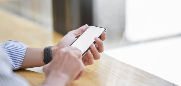 Cropped shot of young businessman using blank screen smartphone 