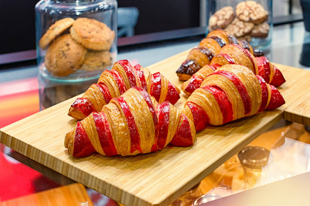 A lot of fresh croissants with raspberry filling 