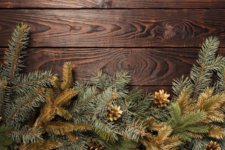 Christmas fir branches  on old dark wooden background 