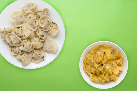  dumplings on a white plate on a colored background. Top view of