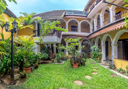 Enclosed Courtyard with Trees and Wooden Bench