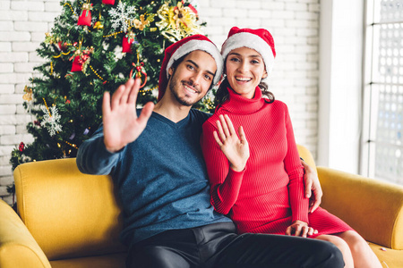 Portrait of happy sweet couple in santa hats having fun smiling 