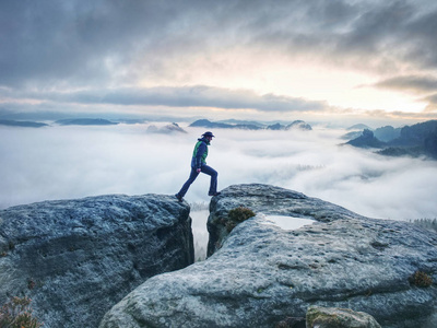 Man finnaly standing on rock and enjoy foggy mountain view 