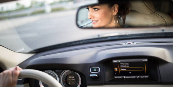 Pretty, young woman  driving a car 