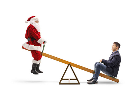 Santa Claus on a seesaw with a young casual man 