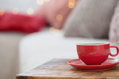 cup of tea on wooden tray on sofa 