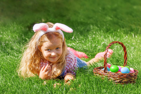 一个可爱的小女孩在花园里收集复活节彩蛋