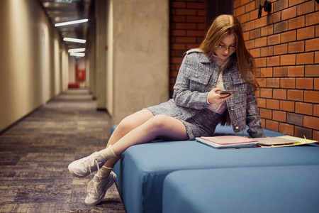 Girl student sit in the corridor of the university  university 