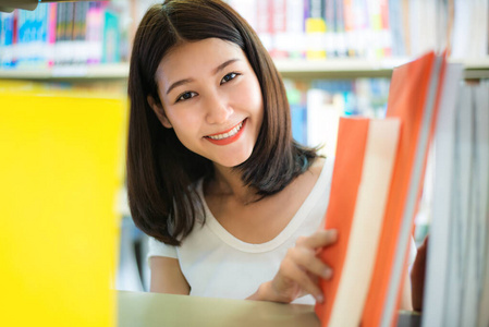 兴高采烈的亚洲女留学生在休息时看书