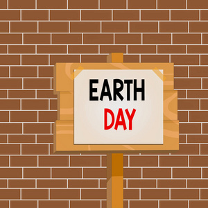 显示地球日的文字标志。概念图全球生态环境保护庆典木板木棍杆纸条附胶带空白处。