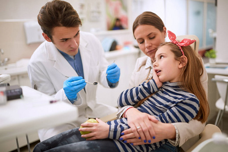 Girl at dentist having toothache  