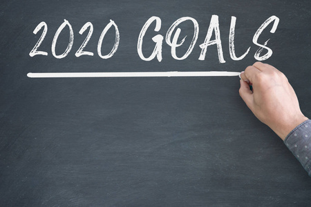 New Year 2020 Goals on Blackboard Background. 