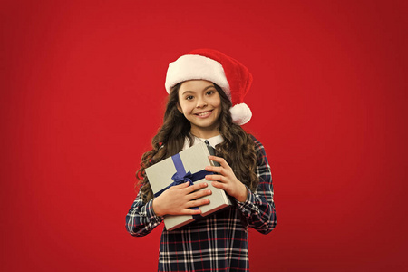戴着圣诞老人红帽子的小女孩。圣诞购物。新年晚会。圣诞老人小子。圣诞礼物。童年。寒假快乐。小女孩。送礼