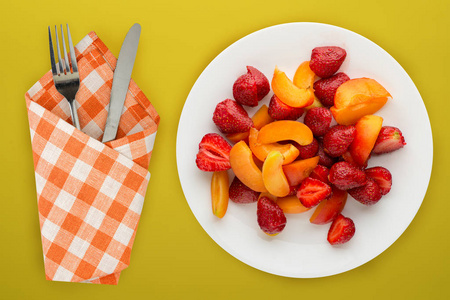 healthy food. Strawberries and apricots on a white plate. fresh 