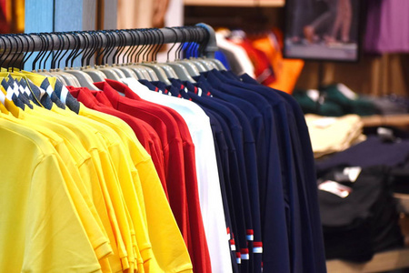 廉价商店商店里挂着衣服的衣架.廉价服装店.照片