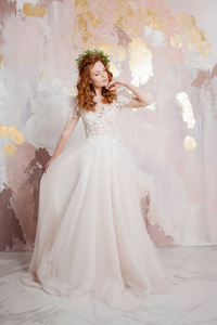 Elegant redhaired girl bride. Young beautiful woman in wedding 