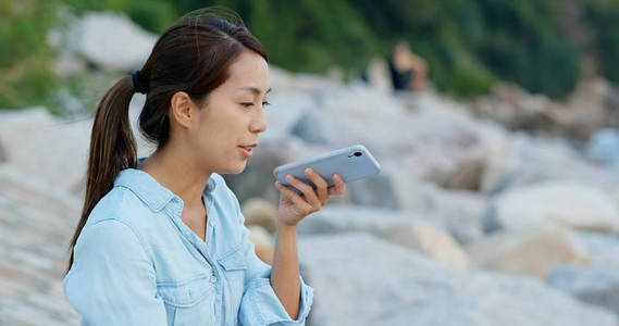 Woman send audio voice message on cellphone 