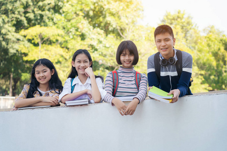 Group of students standing together over wall walkway 